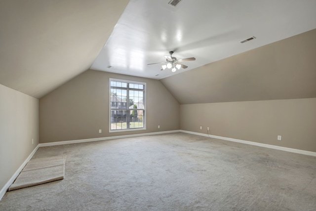 additional living space with lofted ceiling, carpet, and ceiling fan