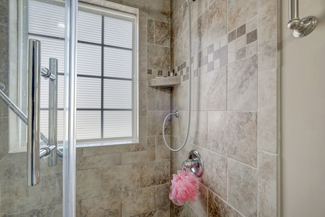 bathroom featuring plenty of natural light and a tile shower