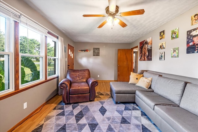 living room featuring dark hardwood / wood-style floors and ceiling fan