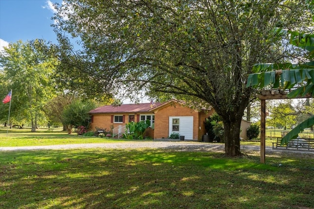 ranch-style house featuring a garage and a front lawn