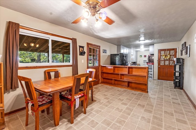 dining area with a textured ceiling and ceiling fan