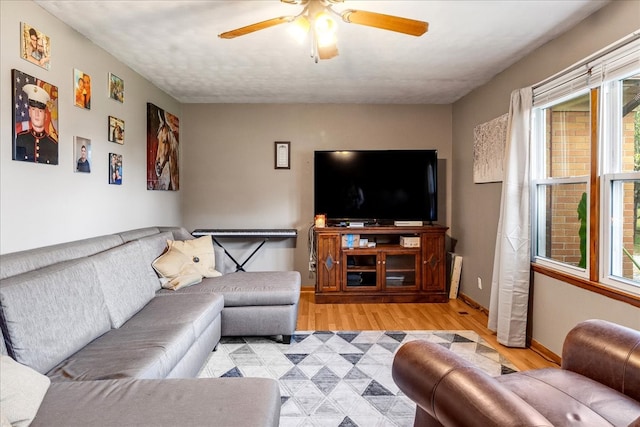 living room featuring light hardwood / wood-style floors and ceiling fan