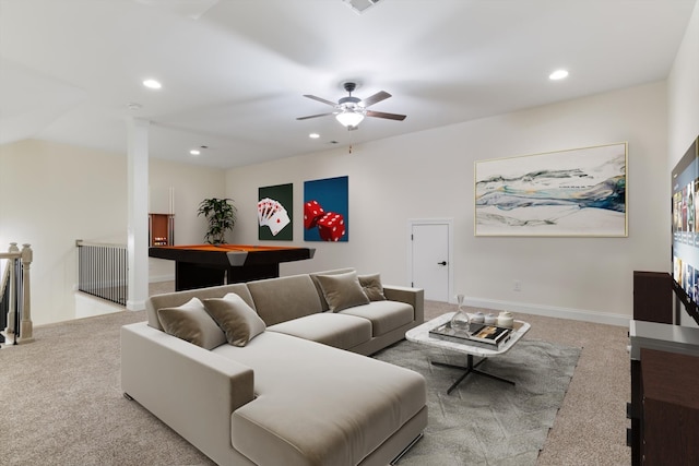 living room featuring ceiling fan, light colored carpet, and ornate columns