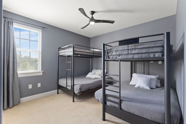 bedroom featuring ceiling fan and carpet