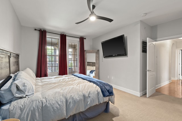 bedroom featuring light carpet and ceiling fan