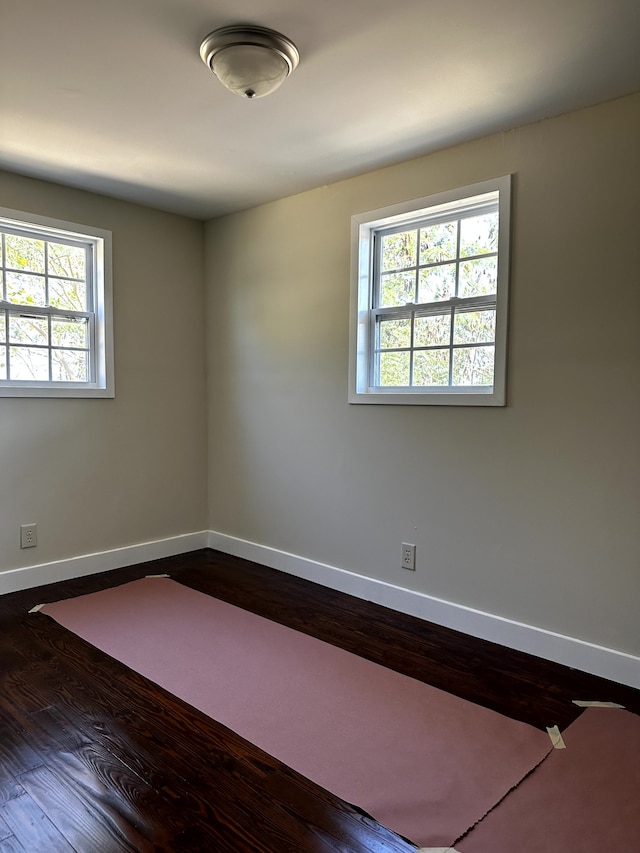 unfurnished room featuring dark hardwood / wood-style floors