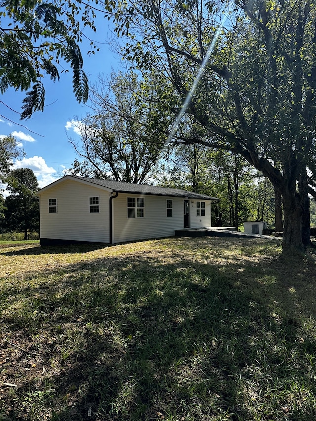 back of property featuring a lawn