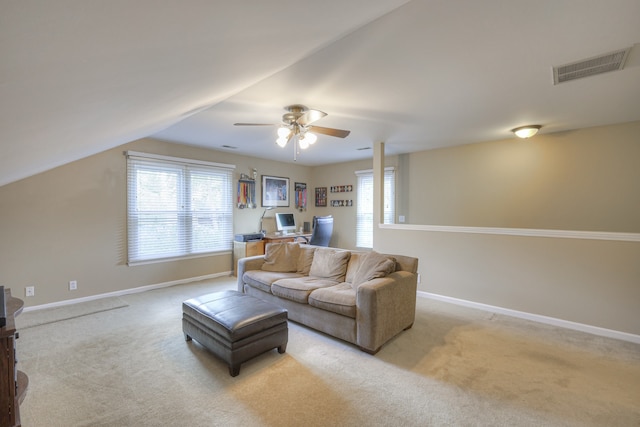 living room featuring light colored carpet, ceiling fan, and vaulted ceiling