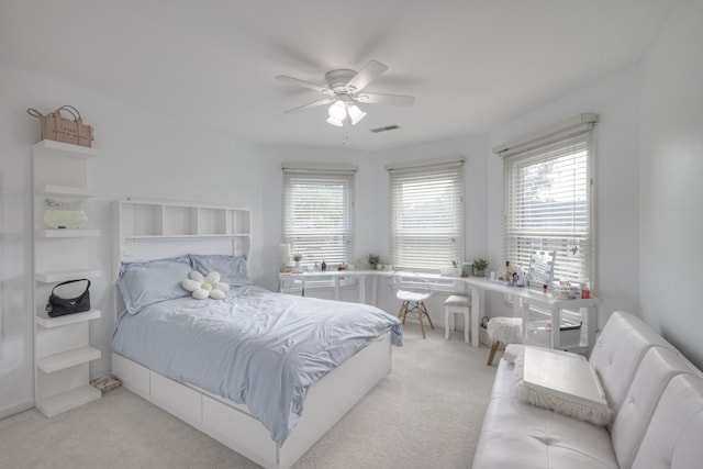 bedroom featuring ceiling fan and light carpet