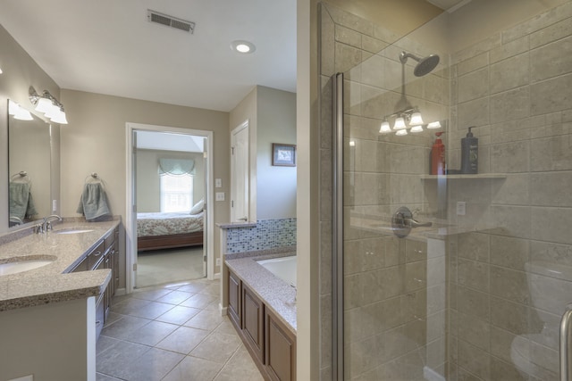 bathroom with vanity, tile patterned floors, and shower with separate bathtub