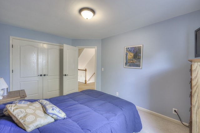 bedroom with light colored carpet and a closet