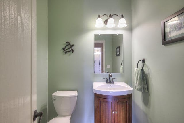 bathroom featuring toilet and vanity