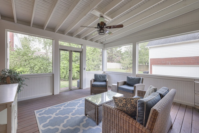 sunroom featuring lofted ceiling with beams, a wealth of natural light, and ceiling fan