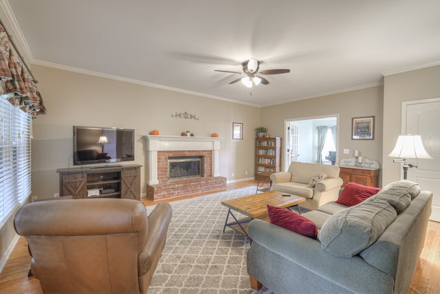 living room with a brick fireplace, light hardwood / wood-style floors, and crown molding