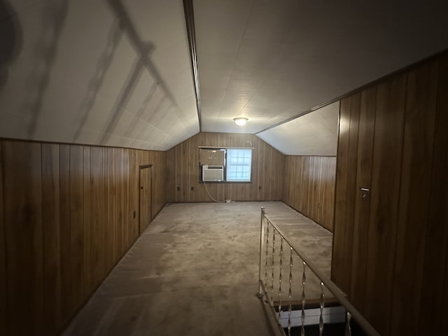 bonus room featuring cooling unit, light colored carpet, wood walls, and vaulted ceiling