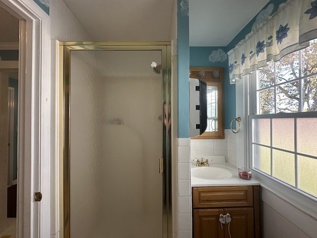 bathroom with walk in shower and vanity