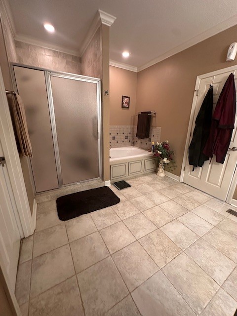 bathroom with ornamental molding, shower with separate bathtub, and tile patterned flooring