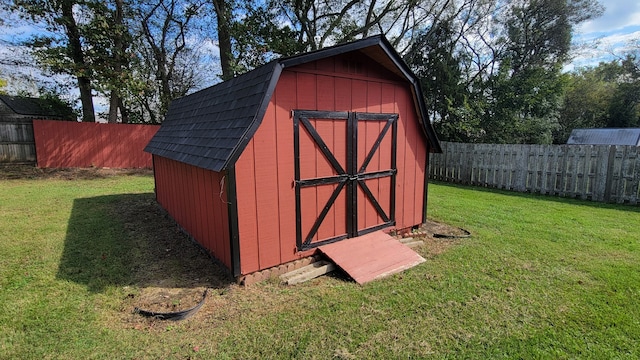 view of outdoor structure featuring a lawn