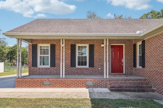 view of exterior entry featuring a porch