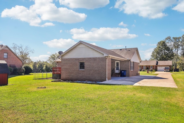 back of property with a patio, a yard, and brick siding