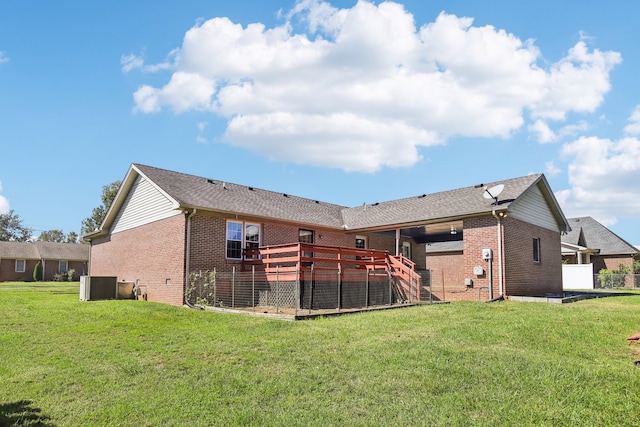 back of house featuring a lawn, cooling unit, and a wooden deck