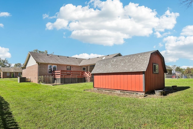 view of yard featuring a shed, central AC, and an outbuilding