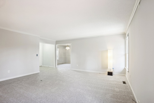 carpeted empty room featuring crown molding