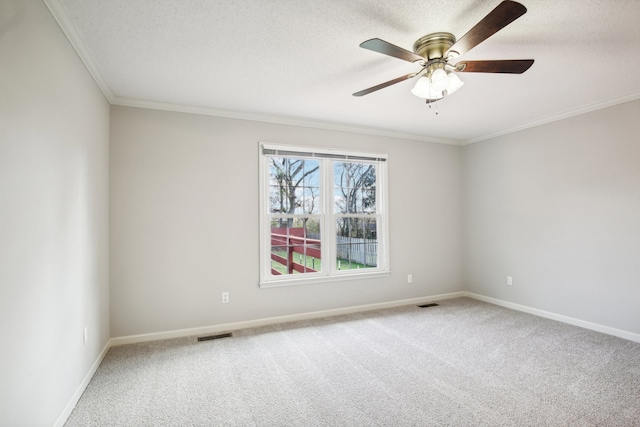 carpeted spare room with ceiling fan, ornamental molding, and a textured ceiling