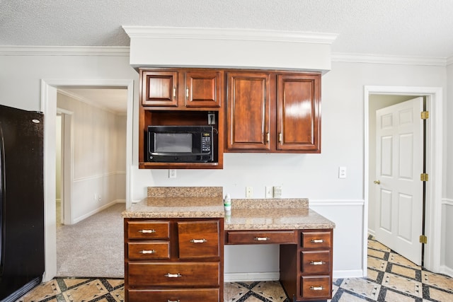 kitchen featuring black appliances, a textured ceiling, and ornamental molding