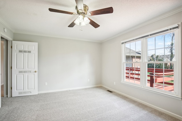 carpeted spare room with crown molding, ceiling fan, and a textured ceiling