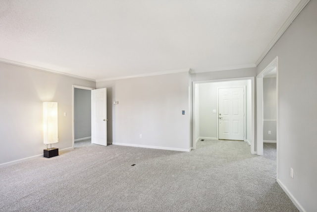 carpeted spare room with crown molding