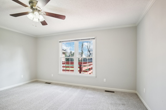 carpeted empty room with a textured ceiling, ceiling fan, and crown molding