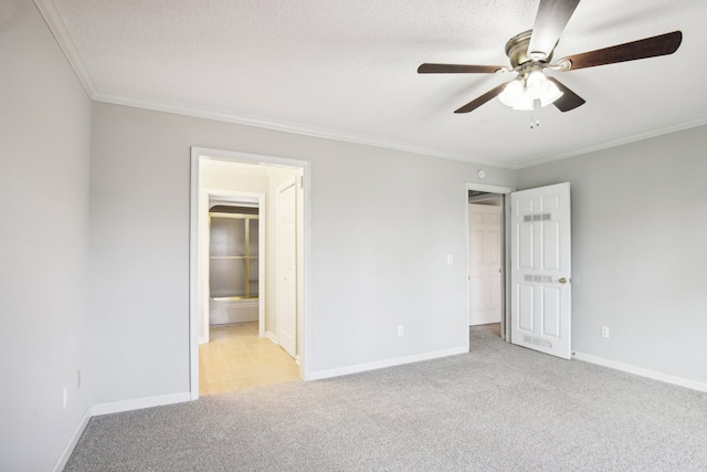 unfurnished bedroom featuring a textured ceiling, ceiling fan, ensuite bathroom, and light carpet