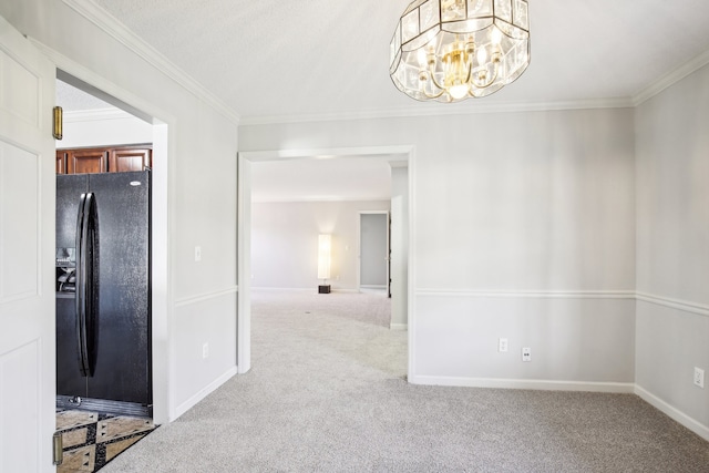 unfurnished dining area featuring carpet flooring, ornamental molding, and a chandelier