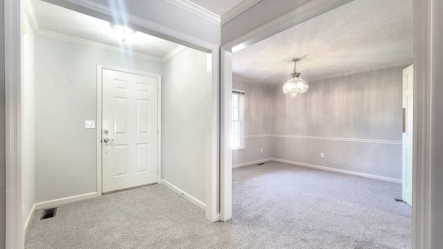 foyer featuring light carpet, a textured ceiling, an inviting chandelier, and crown molding