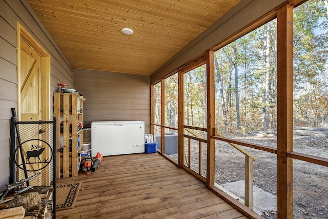 unfurnished sunroom with wooden ceiling