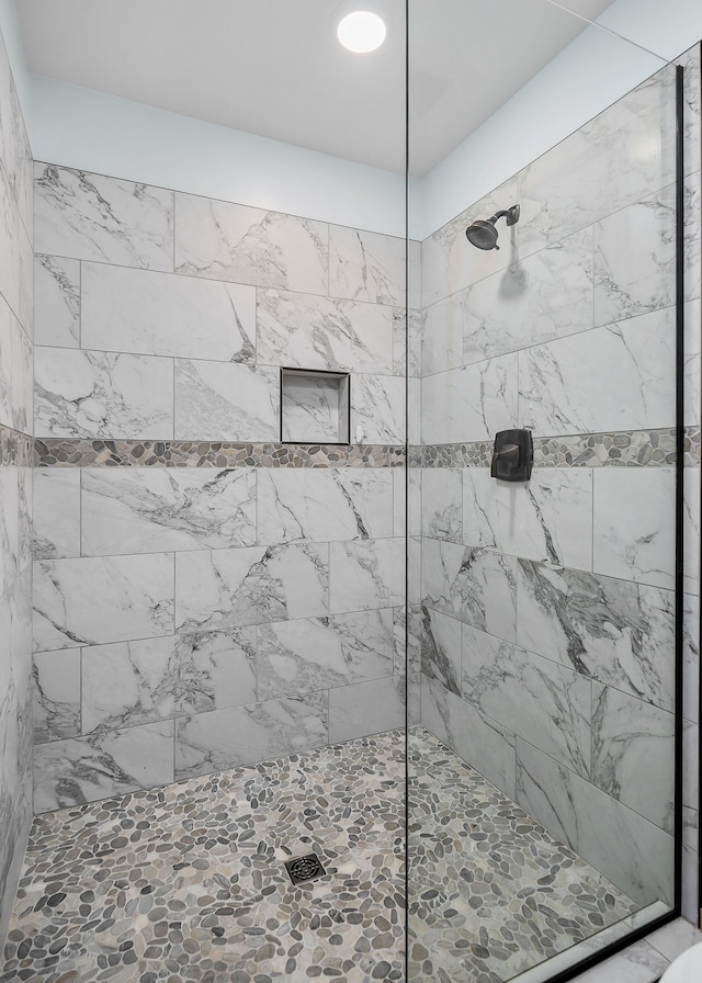 bathroom with a tile shower