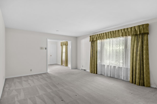 unfurnished room with light carpet