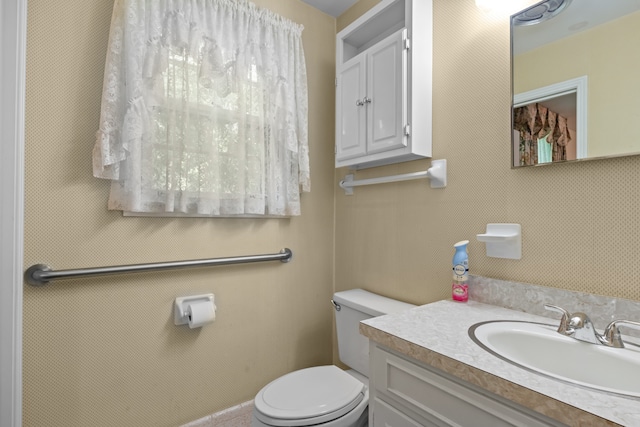 bathroom featuring vanity and toilet