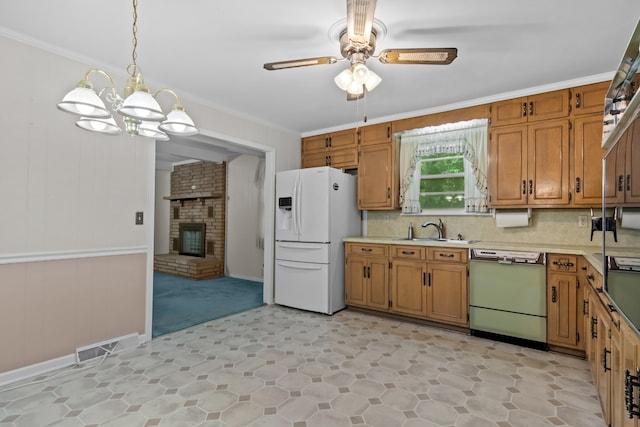 kitchen featuring dishwasher, white refrigerator with ice dispenser, sink, a brick fireplace, and backsplash
