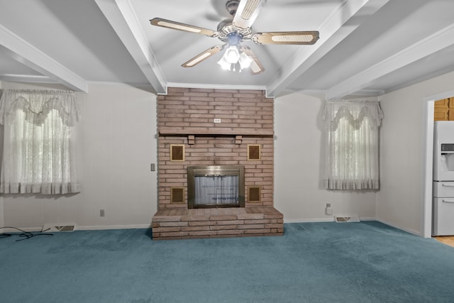 unfurnished living room with ornamental molding, carpet, ceiling fan, and a fireplace