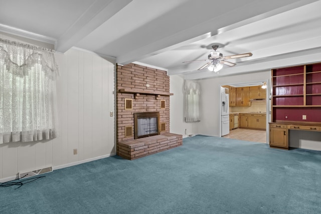 unfurnished living room featuring light carpet, a brick fireplace, ceiling fan, and beamed ceiling