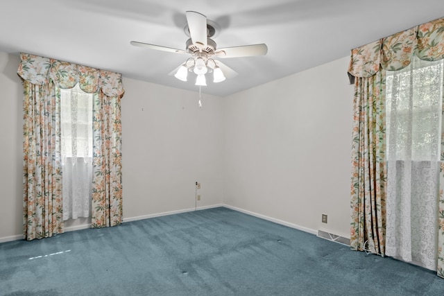 carpeted spare room with a healthy amount of sunlight and ceiling fan