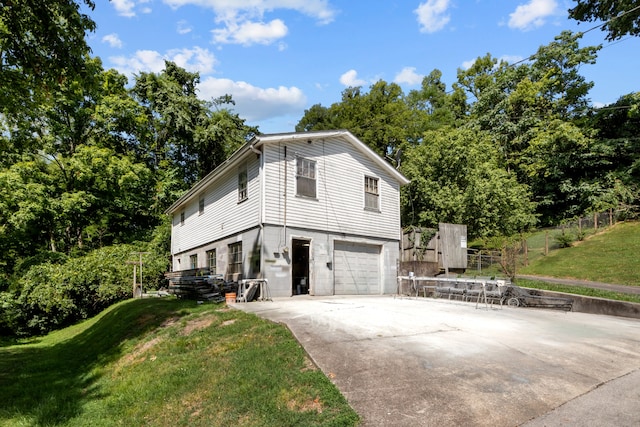 view of property exterior with a garage and a lawn