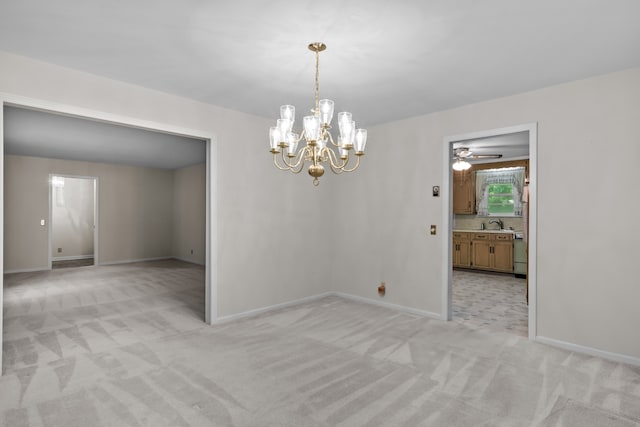 carpeted spare room featuring ceiling fan with notable chandelier
