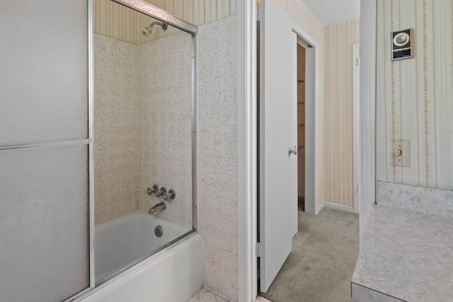 bathroom featuring shower / bath combination with glass door