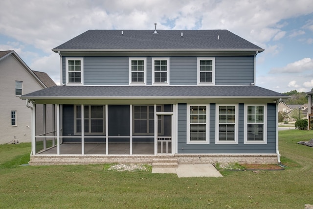 back of property with a lawn and a sunroom