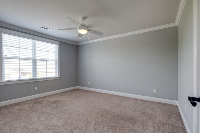 carpeted spare room featuring ceiling fan and crown molding