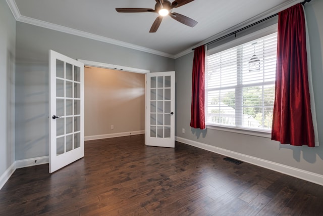 empty room featuring crown molding, ceiling fan, dark wood-type flooring, and french doors