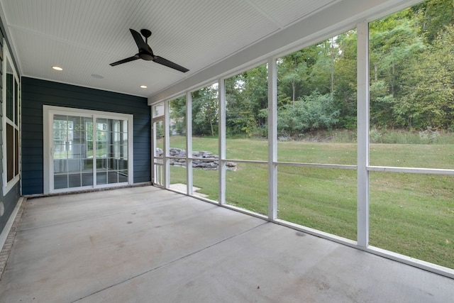 unfurnished sunroom with ceiling fan